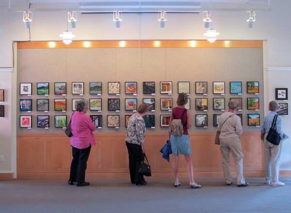 A wall of art for the 10X10 Benefit Art Exhibit & Sale